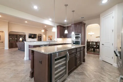 a kitchen with stainless steel appliances granite countertop counter space and wooden floors