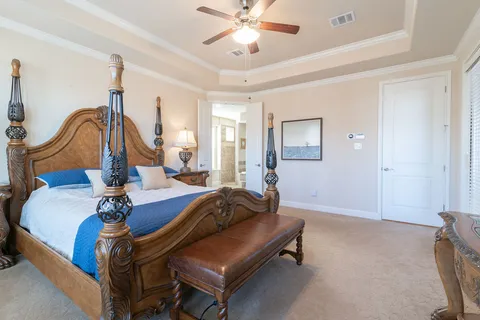 a living room with furniture a chandelier and a rug