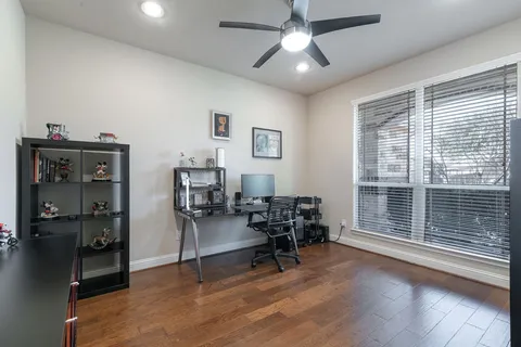 a view of a livingroom with workspace and a window