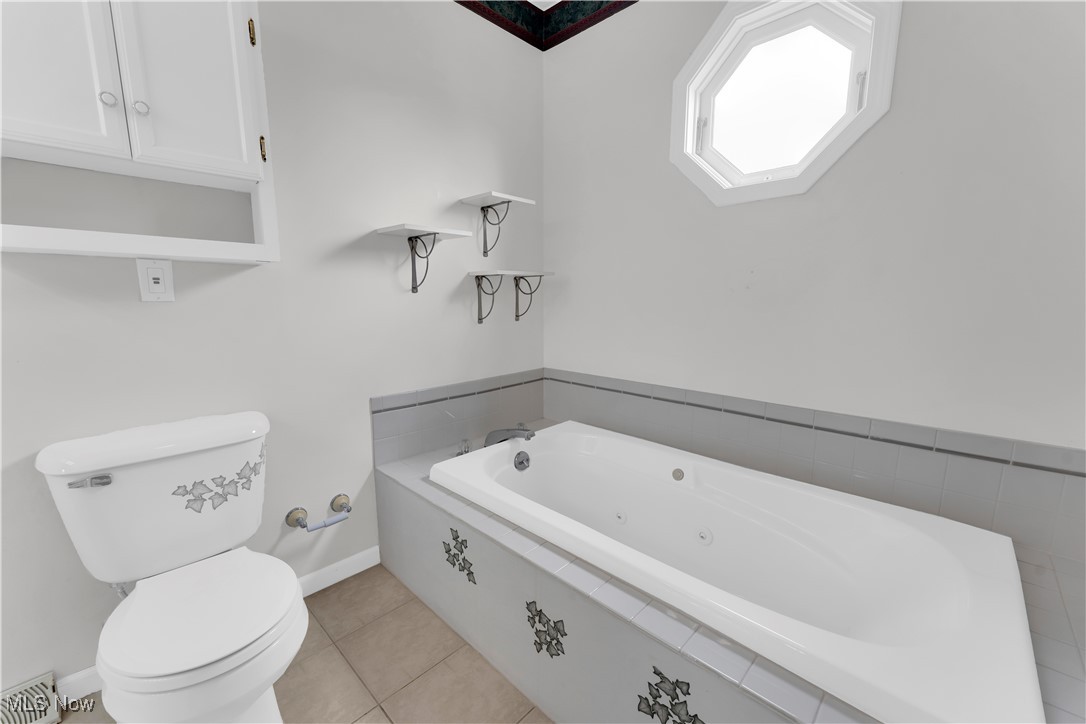 8651 State Road North Royalton, OH 44133 - Photo 21 of 33 Bathroom with a tub with jets and light tile patterned floors