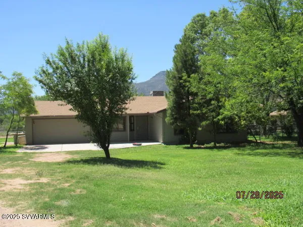 a view of a house with yard and tree s
