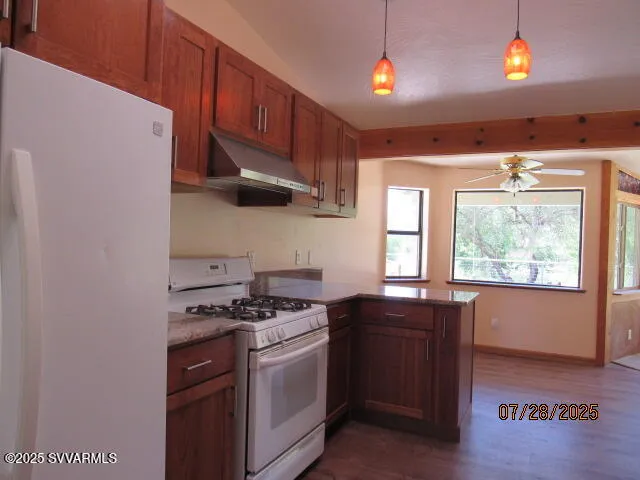 a kitchen with stainless steel appliances a stove and a refrigerator