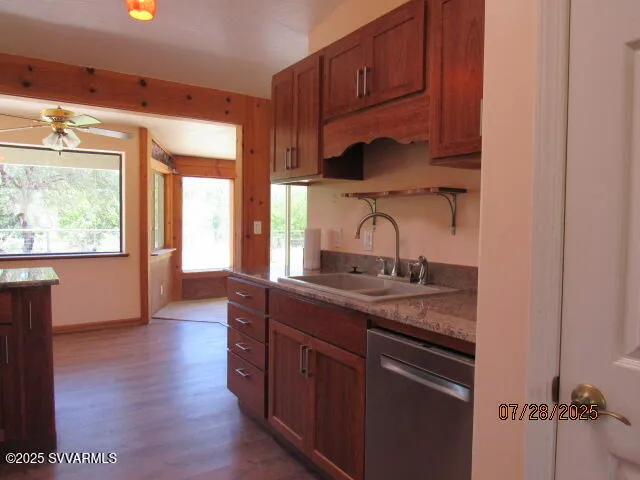 a kitchen with stainless steel appliances granite countertop a sink stove and cabinets