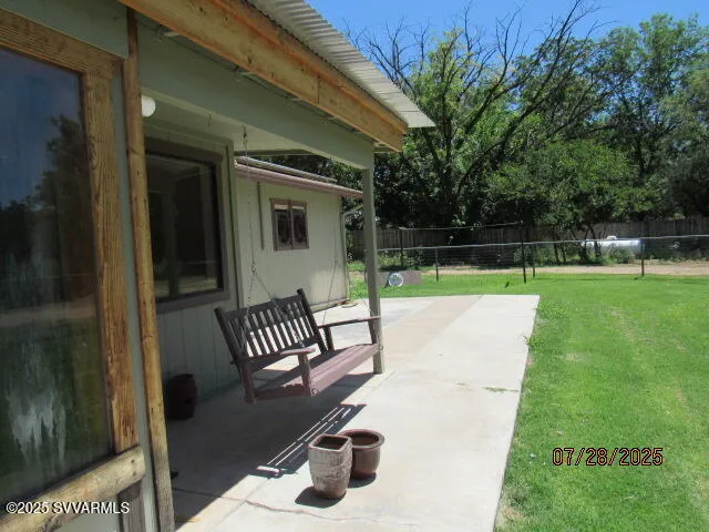 a view of a chair and table in the garden