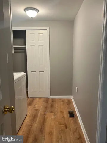 a white toilet sitting next to a window in a bathroom
