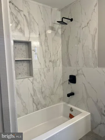 a bathroom with a granite countertop sink a toilet and mirror