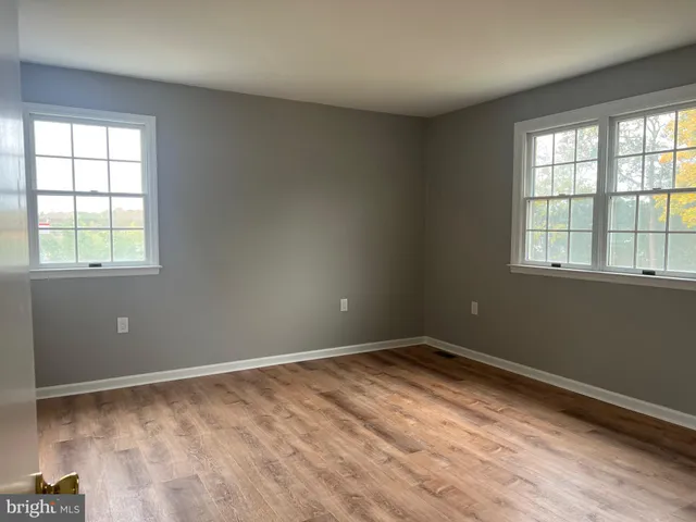 an empty room with closet and a bathroom