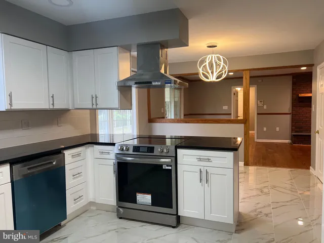 a kitchen with stainless steel appliances granite countertop a sink and a stove