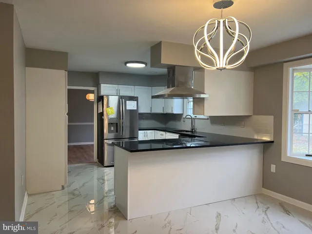 a view of empty room with wooden floor and fireplace
