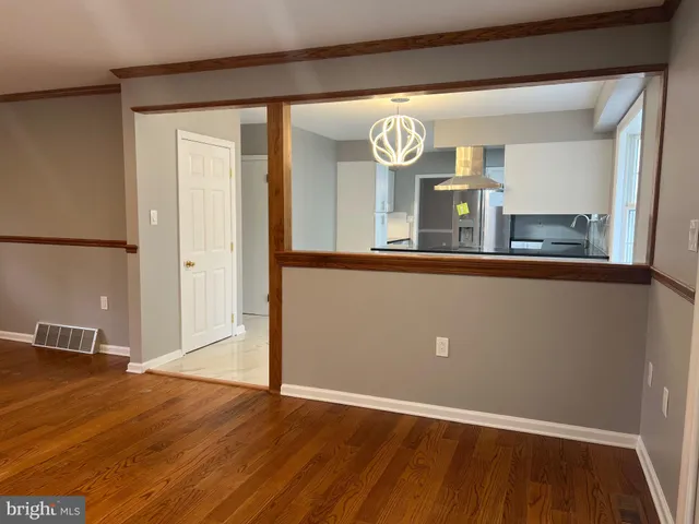 an empty room with wooden floor and a window