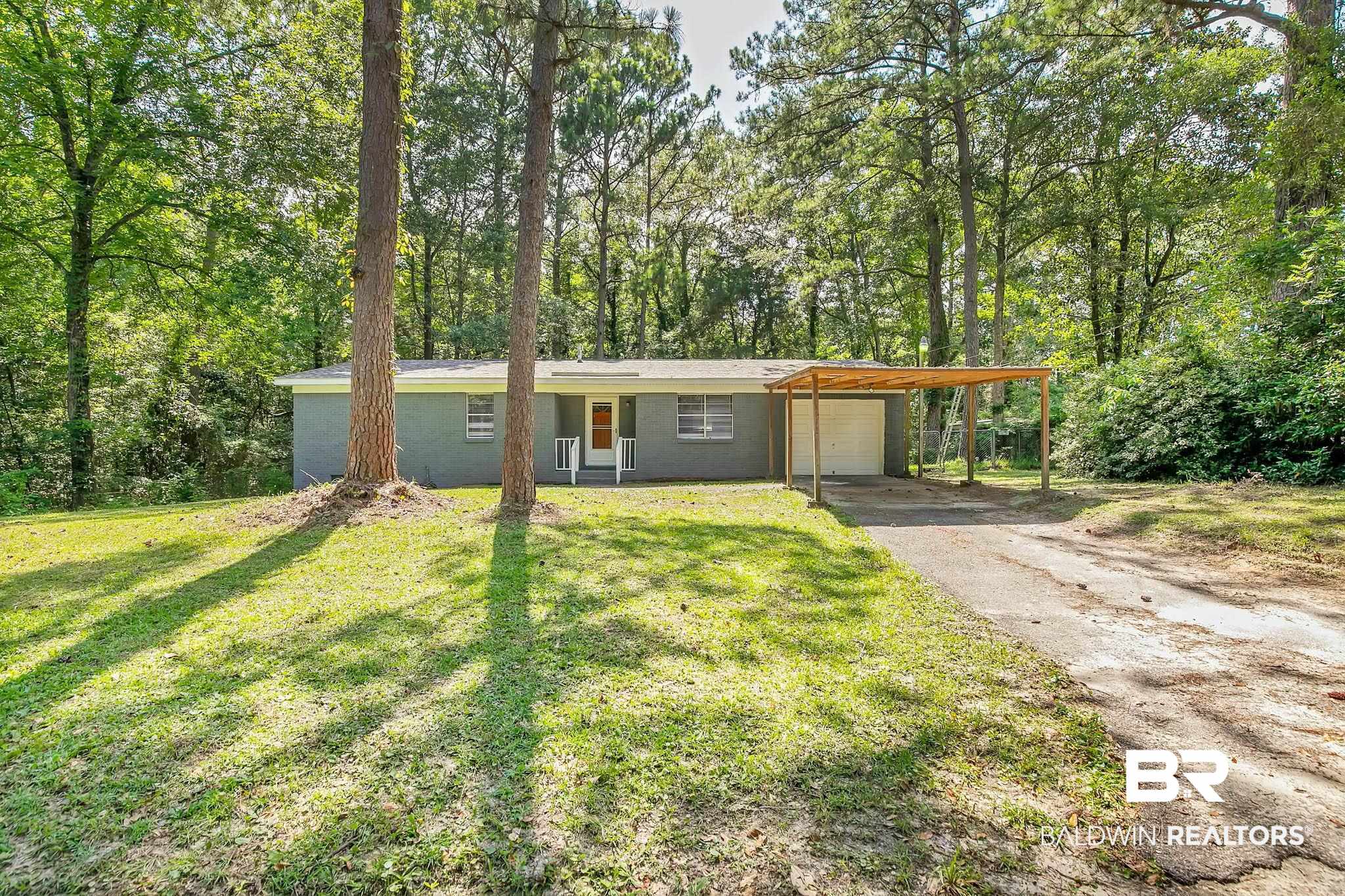 3304 Armond Drive Mobile, AL 36605 - Photo 3 of 62 View of front facade featuring driveway, an attached carport, and a front lawn