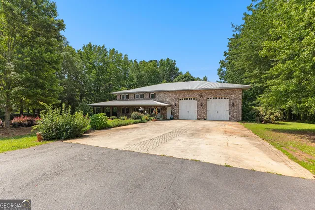 a living room with furniture and large windows