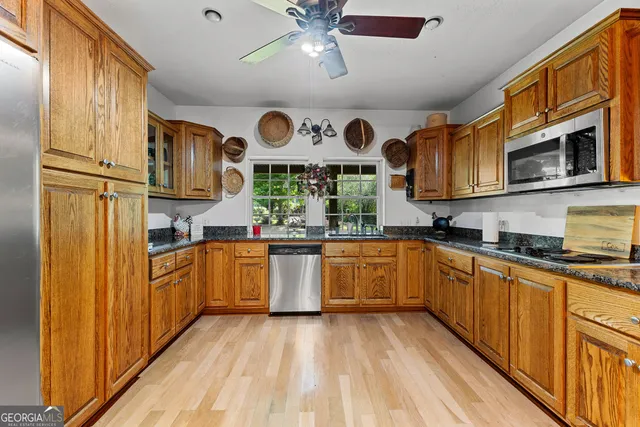 a bedroom with a large bed and a flat tv screen on dresser