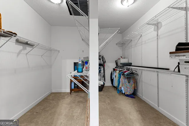 a bedroom with a bed and cabinet