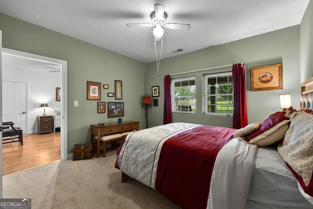 a bedroom with a bed and a ceiling fan