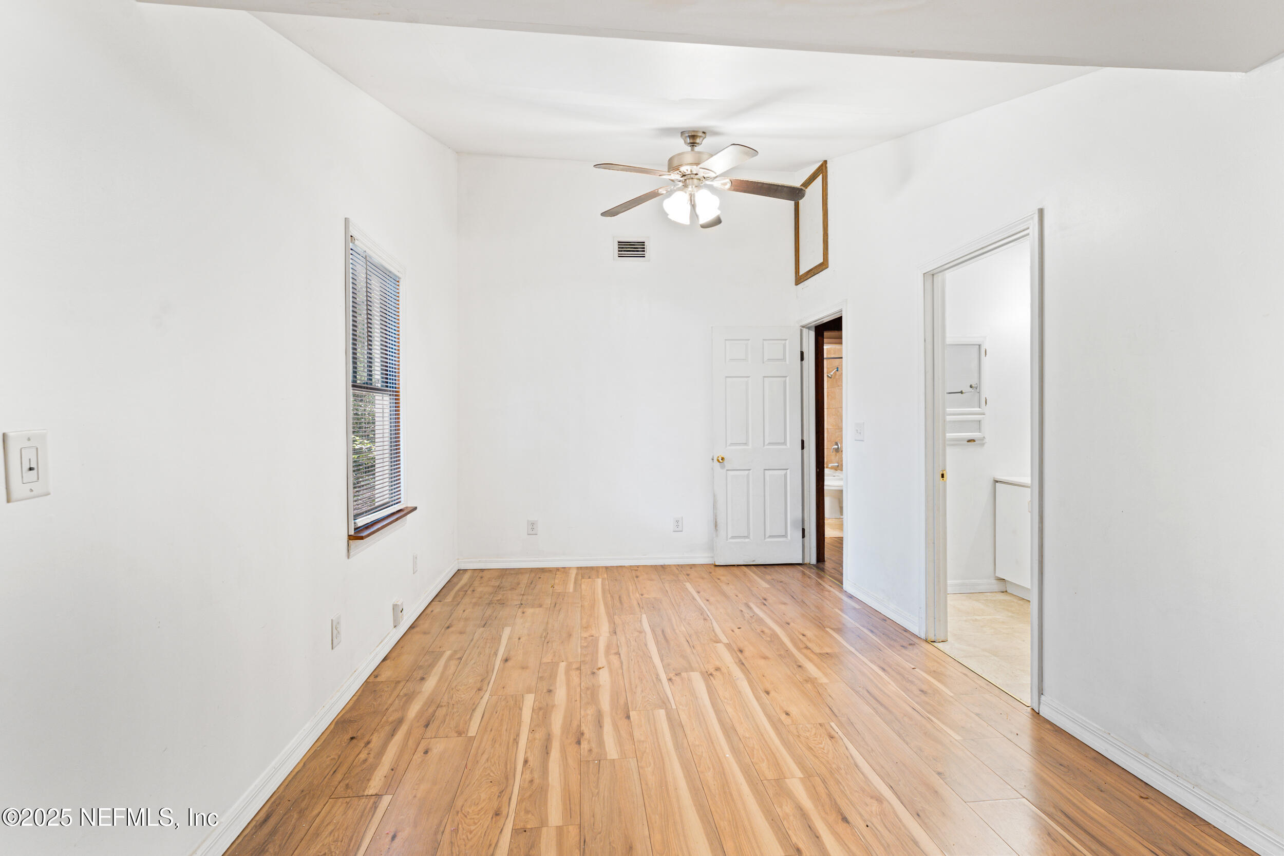 610 Division Street Fernandina Beach, FL 32034 - Photo 12 of 40 a view of empty room with wooden floor and fan