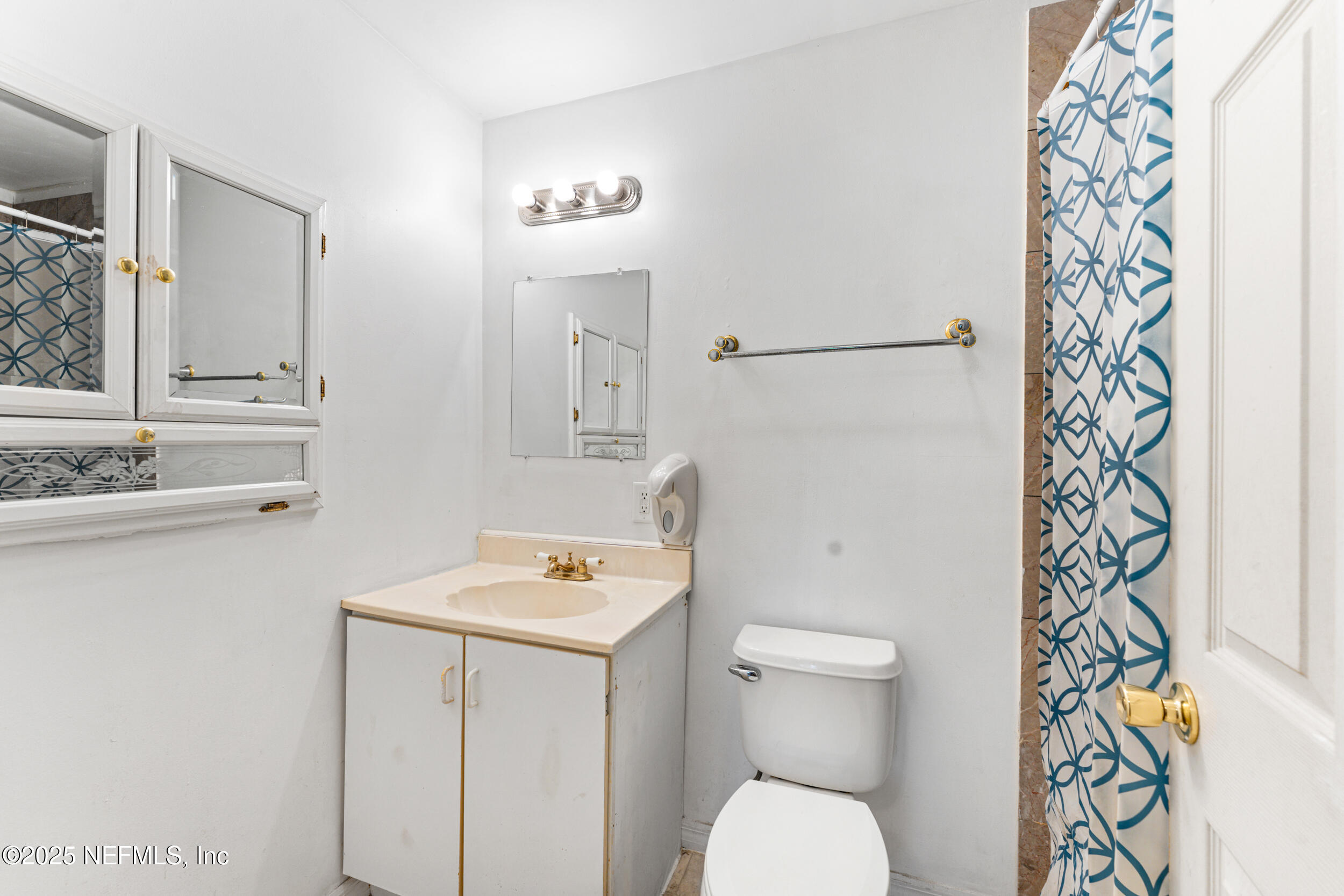 610 Division Street Fernandina Beach, FL 32034 - Photo 13 of 40 a white toilet sitting next to a bathroom sink