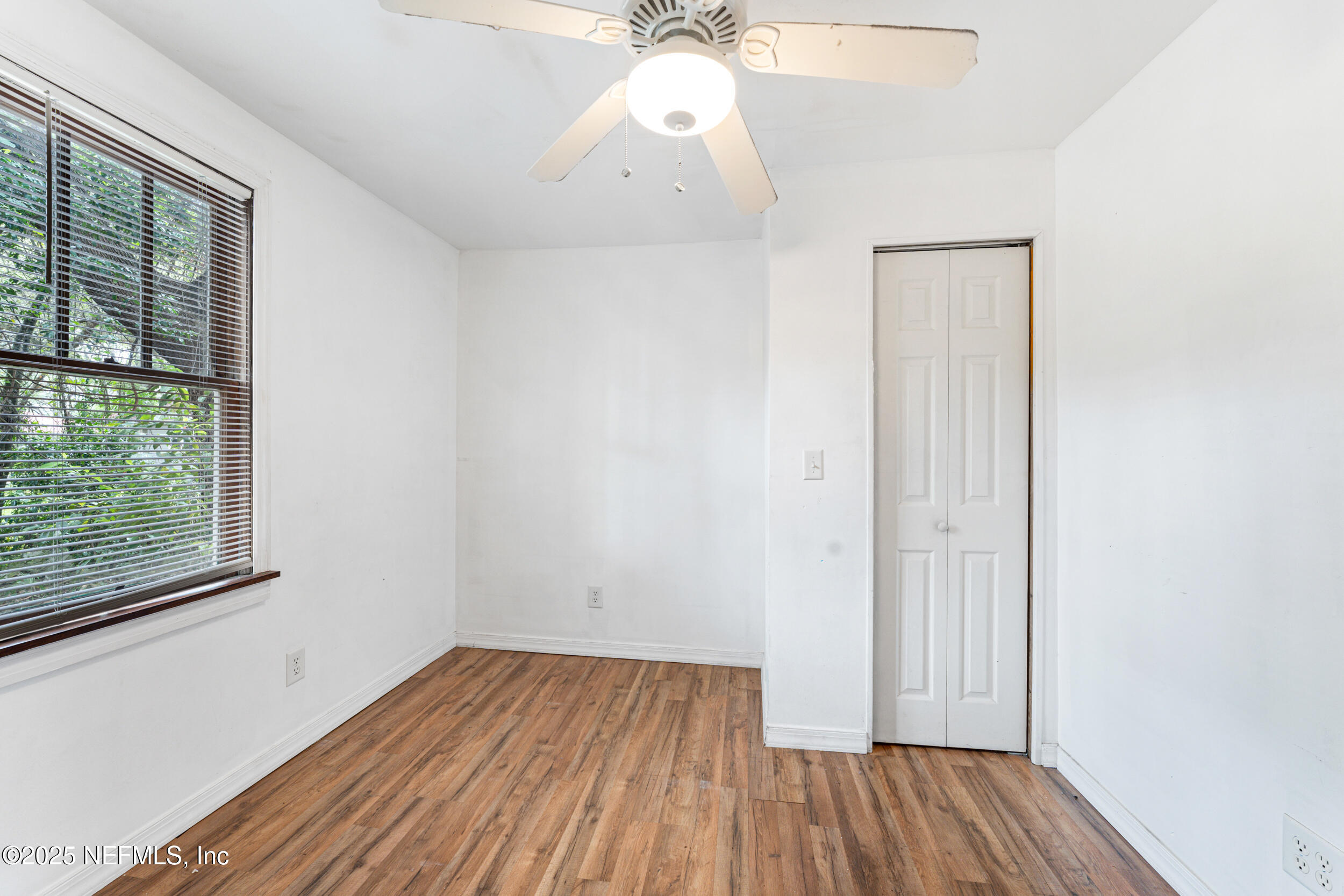 610 Division Street Fernandina Beach, FL 32034 - Photo 14 of 40 a view of a room with wooden floor fan and windows