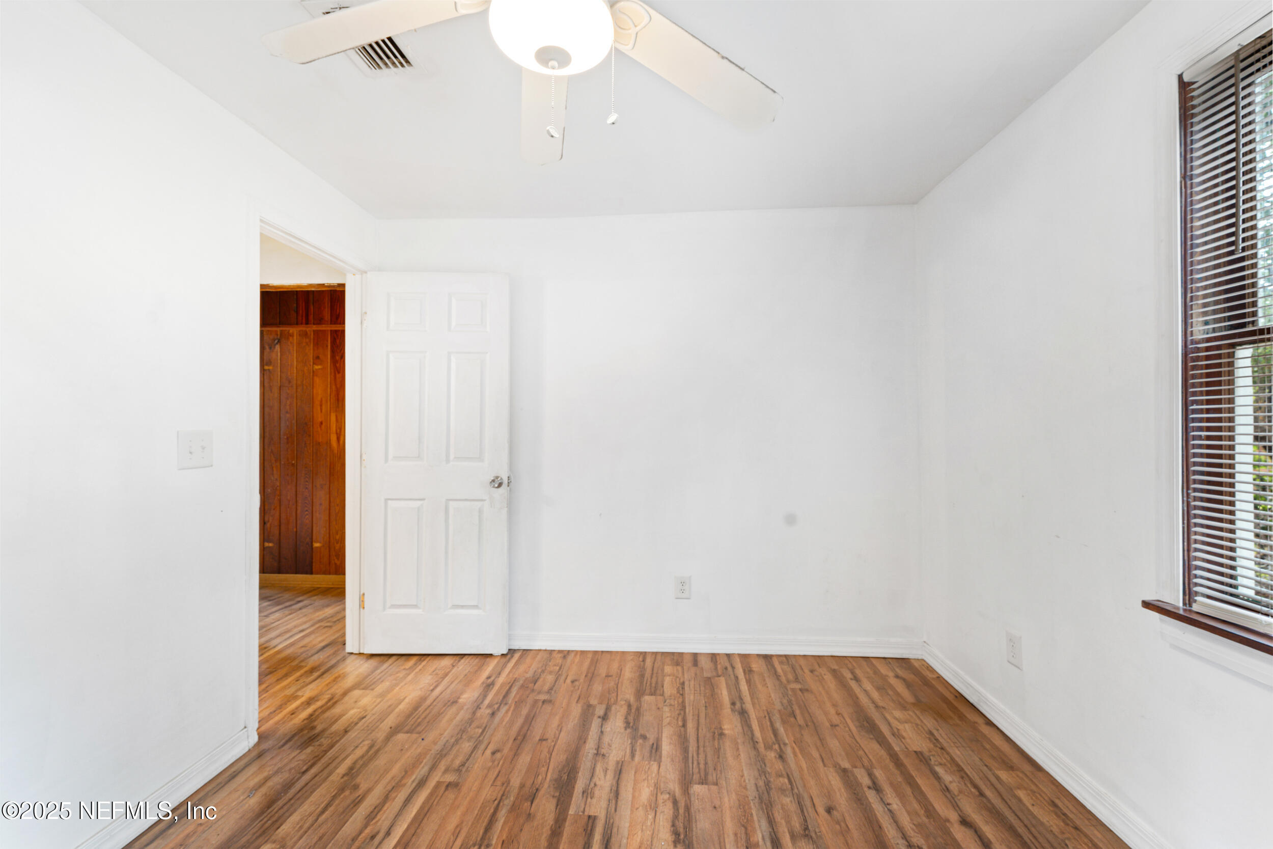 610 Division Street Fernandina Beach, FL 32034 - Photo 15 of 40 a view of a small space with wooden floor and a window
