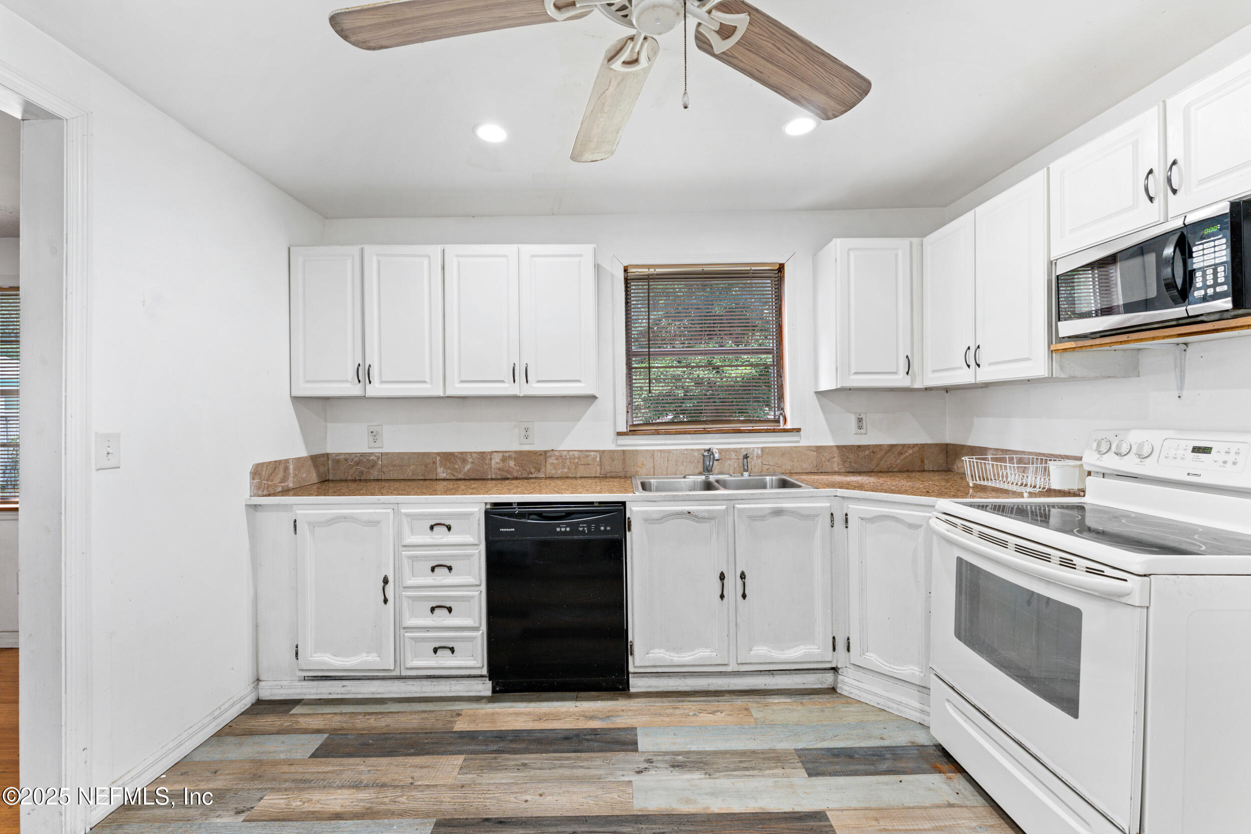 610 Division Street Fernandina Beach, FL 32034 - Photo 18 of 40 a kitchen with stainless steel appliances granite countertop a stove and a sink