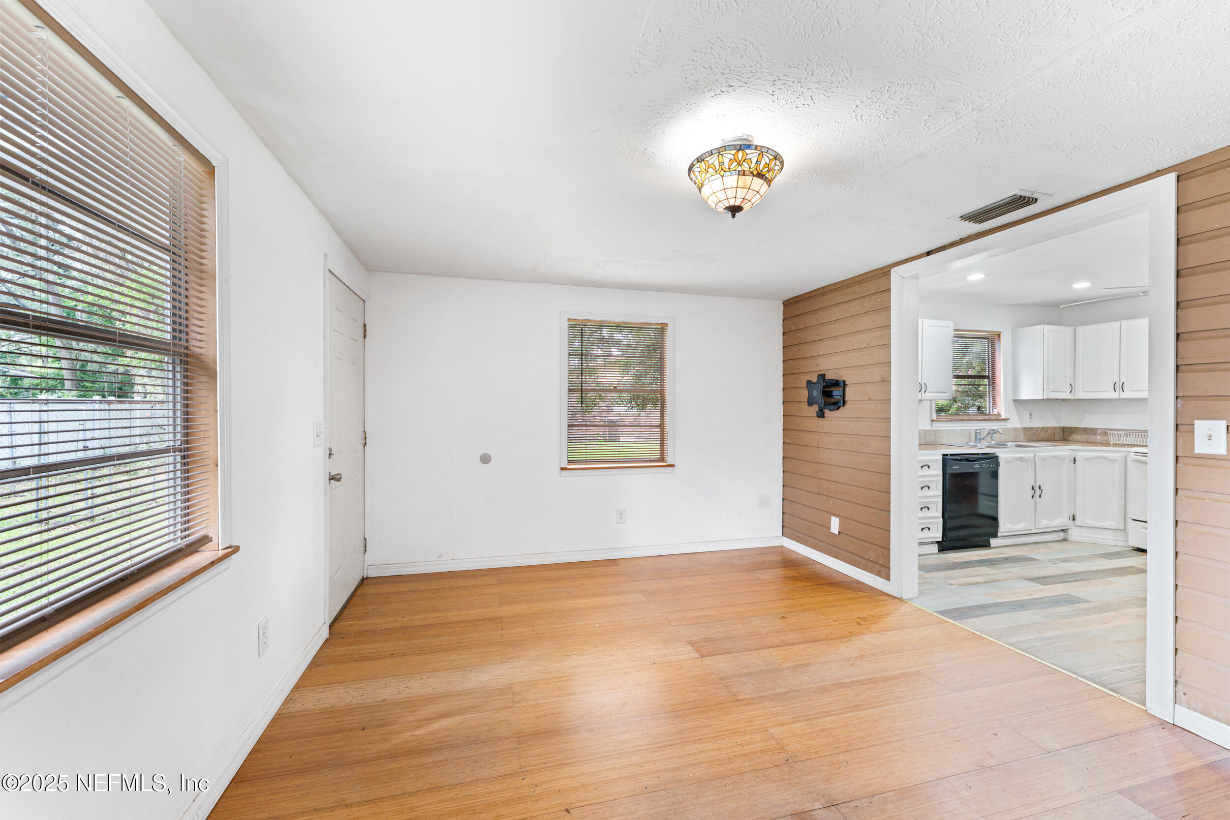 610 Division Street Fernandina Beach, FL 32034 - Photo 20 of 40 a view of an empty room with kitchen and a window