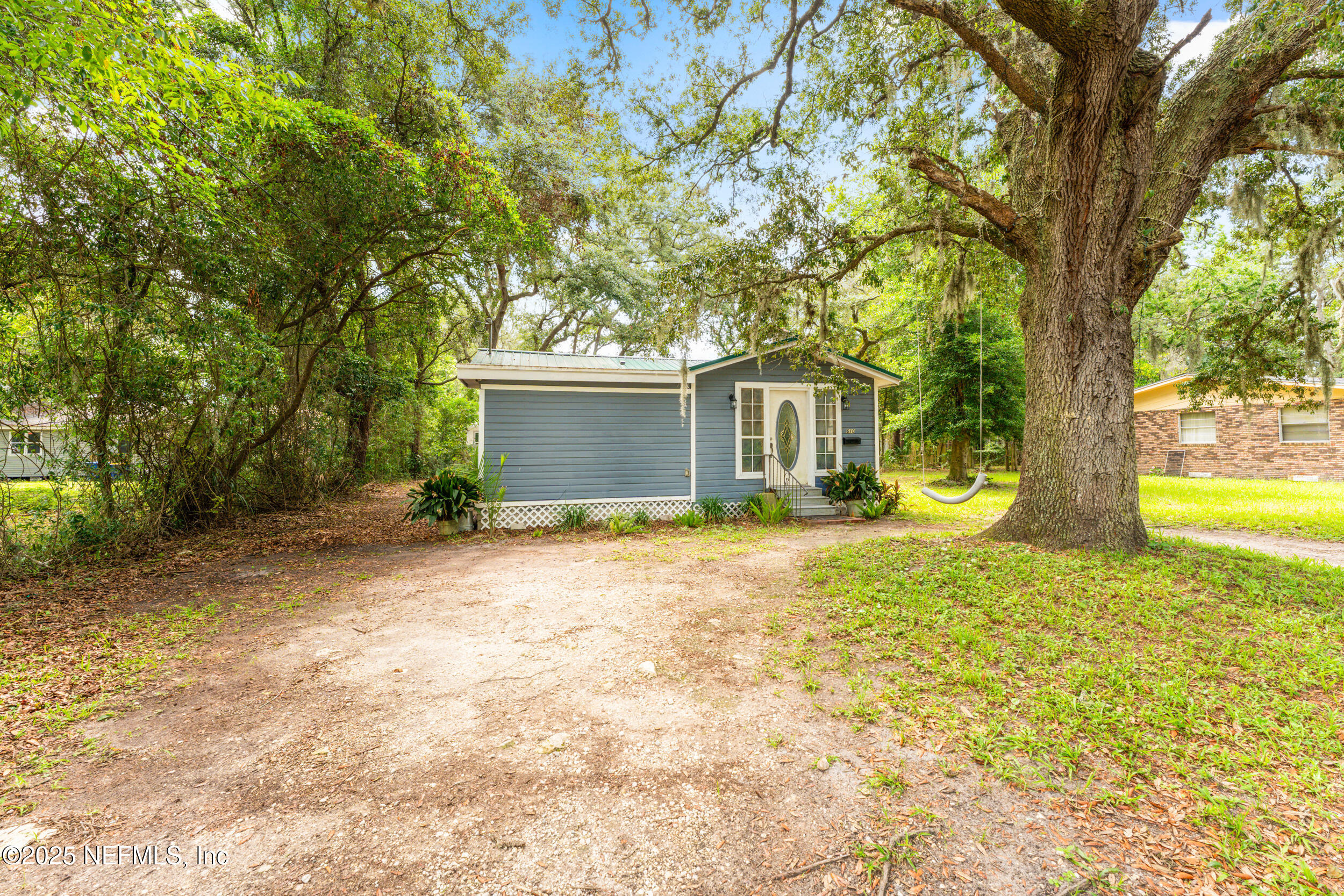 610 Division Street Fernandina Beach, FL 32034 - Photo 3 of 40 a view of a house with backyard and tree