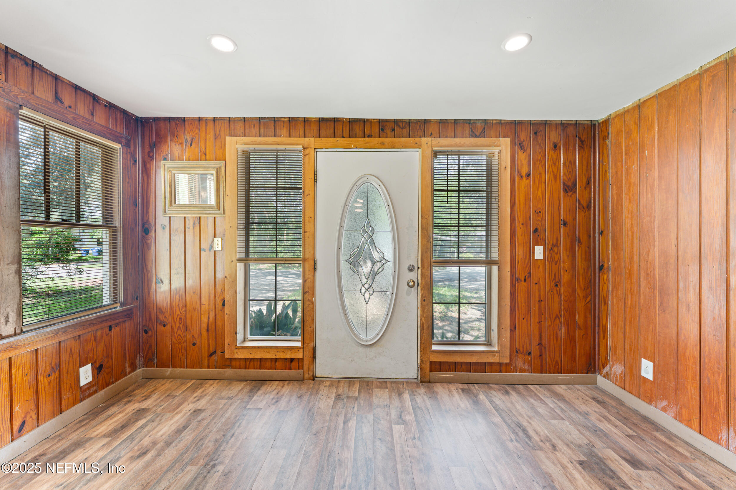 610 Division Street Fernandina Beach, FL 32034 - Photo 7 of 40 a view of an entryway with wooden floor and door
