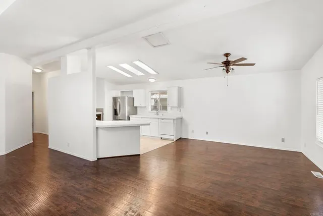 a view of a kitchen with a sink and a window