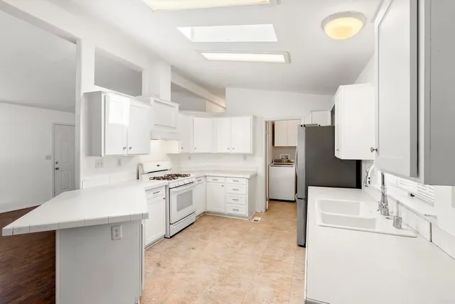 a kitchen with a sink a stove and refrigerator