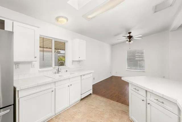 a spacious bathroom with a granite countertop sink a mirror and a