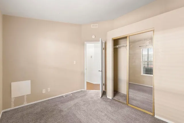 an empty room with closet area