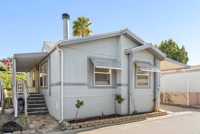 a view of a house with wooden fence