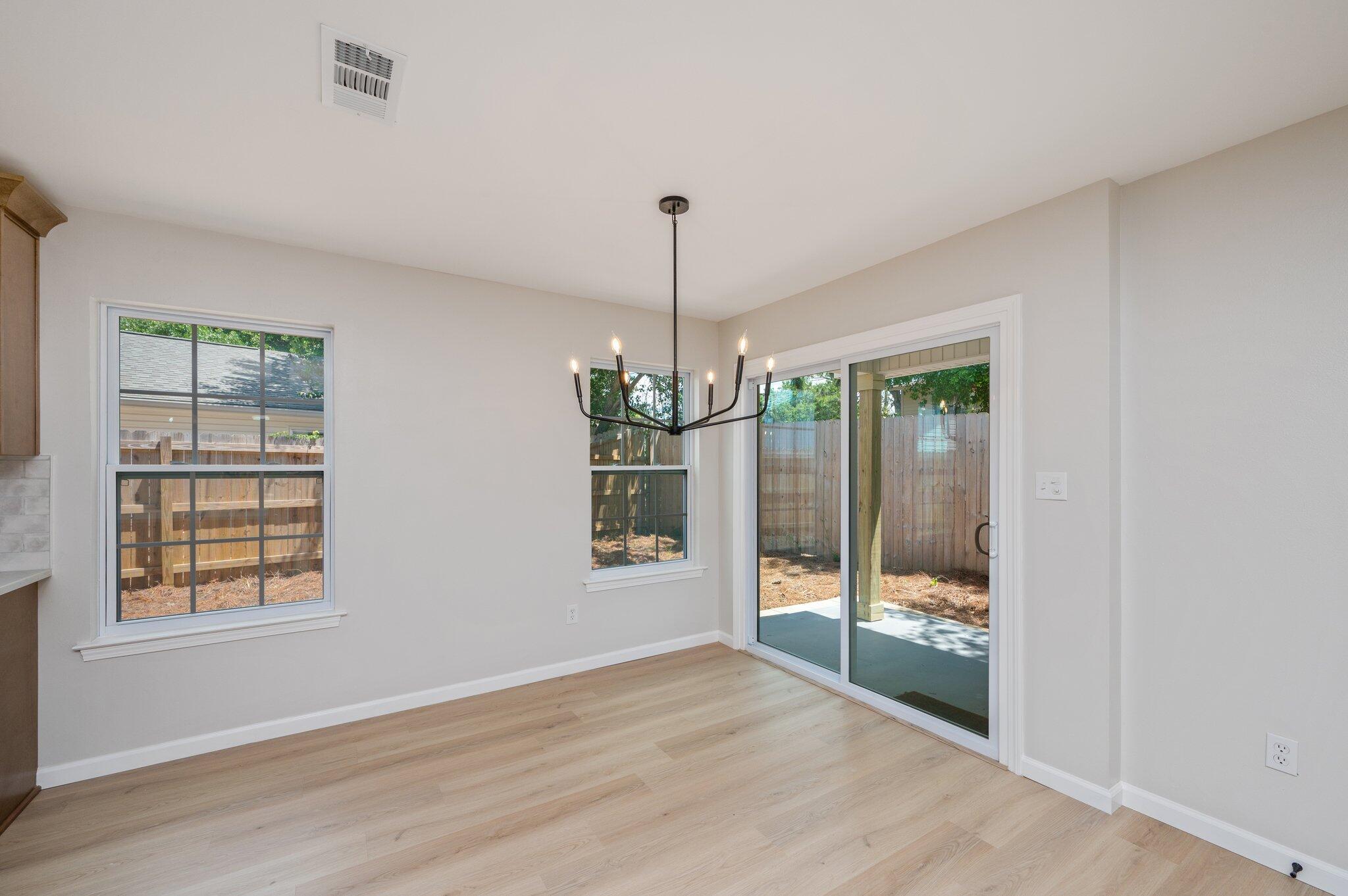 55 Ruby Circle Mary Esther, FL 32569 - Photo 11 of 51 a view of an empty room with glass door and windows