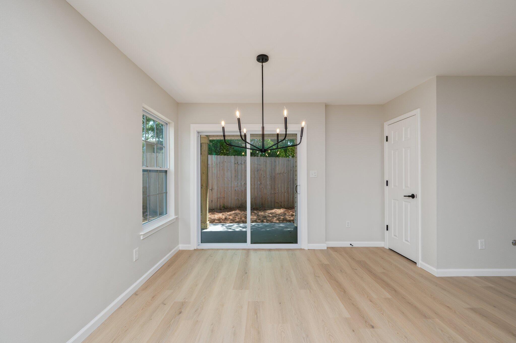 55 Ruby Circle Mary Esther, FL 32569 - Photo 12 of 51 a empty room with window and wooden floor