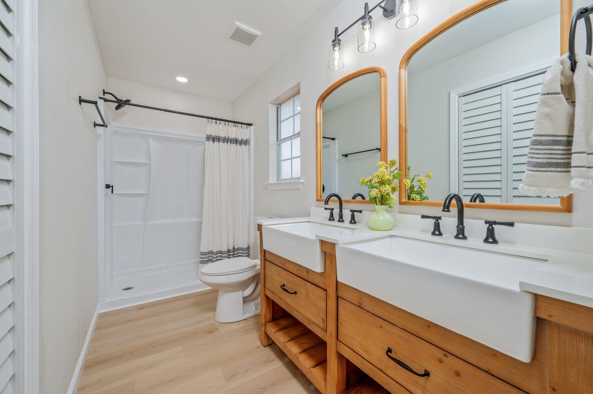 55 Ruby Circle Mary Esther, FL 32569 - Photo 28 of 51 a bathroom with a double vanity sink toilet and a mirror