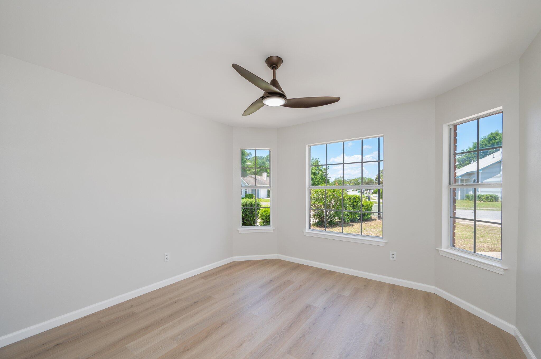 55 Ruby Circle Mary Esther, FL 32569 - Photo 32 of 51 a view of an empty room with wooden floor and a window