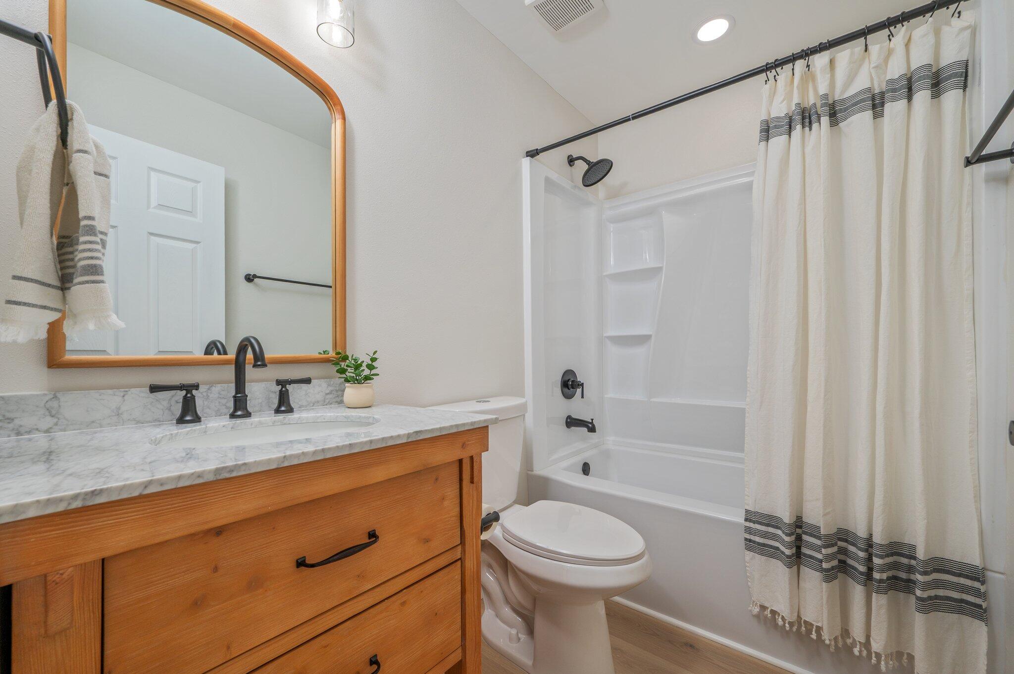 55 Ruby Circle Mary Esther, FL 32569 - Photo 36 of 51 a bathroom with a granite countertop sink toilet a mirror a vanity and shower