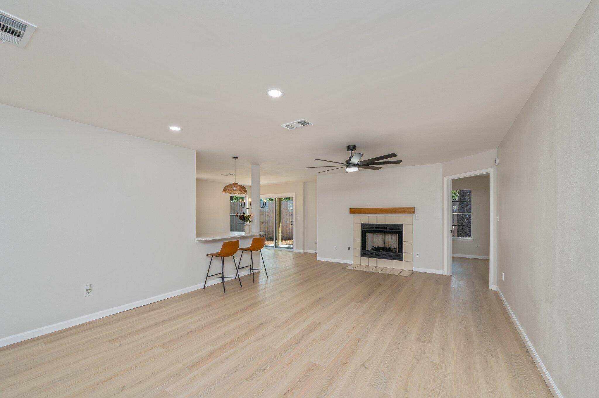 55 Ruby Circle Mary Esther, FL 32569 - Photo 7 of 51 wooden floor fireplace and windows in an empty room
