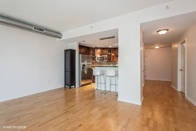 a view of a kitchen with a refrigerator and a sink