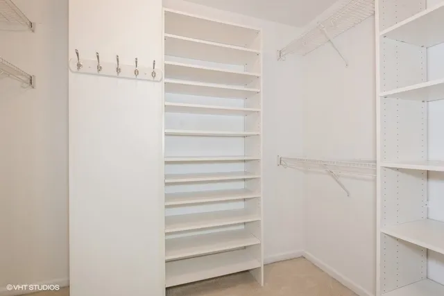 a view of walk in closet with empty racks