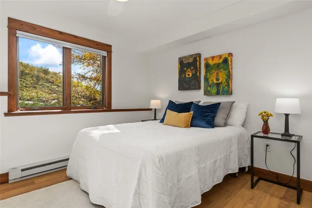 a bed room with a bed and painting on wall