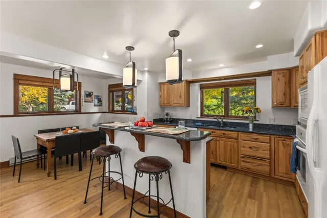 a kitchen with stainless steel appliances granite countertop sink stove and refrigerator