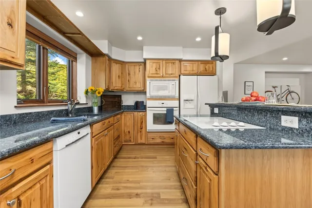 a kitchen with a sink appliances and cabinets