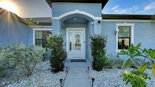 a living room with furniture floor to ceiling window and wooden floor