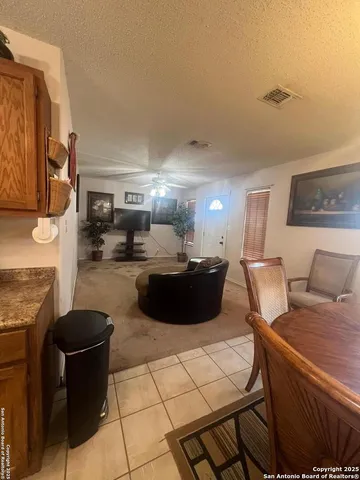 a large kitchen with a table and chairs