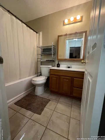 a bathroom with a sink a toilet and mirror