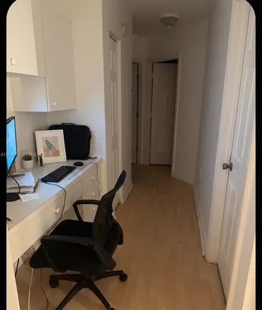 a view of workspace with wooden floor