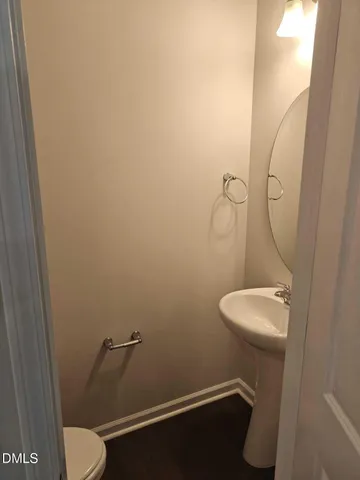 a bathroom with a sink mirror and toilet