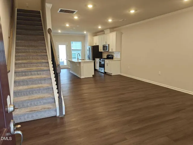 a view of kitchen with cabinets and wooden floor