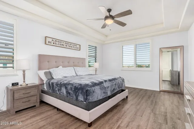 a bedroom with a bed and a chandelier